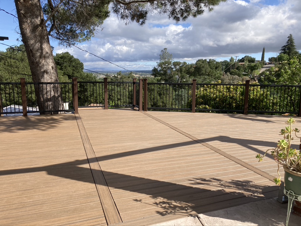 Large custom composite deck beneath mature trees